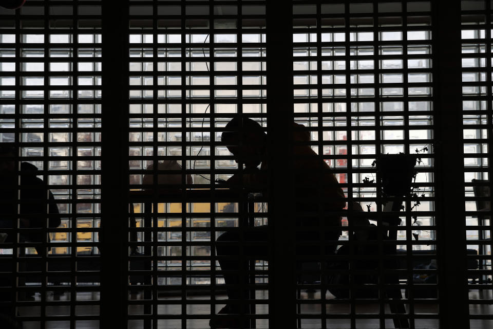 FILE - In this file photo dated Thursday, April 2, 2020, a man takes a rest in the "Aurore" center for homeless and migrant people in Paris, amid the coronavirus lockdown. A breakthrough study released Tuesday July 7, 2020, from the French government's statistics agency INSEE, shows that death rates doubled among immigrants from sub-Saharan Africa, even tripling in the Paris region, at the height of France's coronavirus outbreak, exposing the pandemic's punishing impact on Black, migrant and other systematically overlooked minorities. (AP Photo/Francois Mori, FILE)