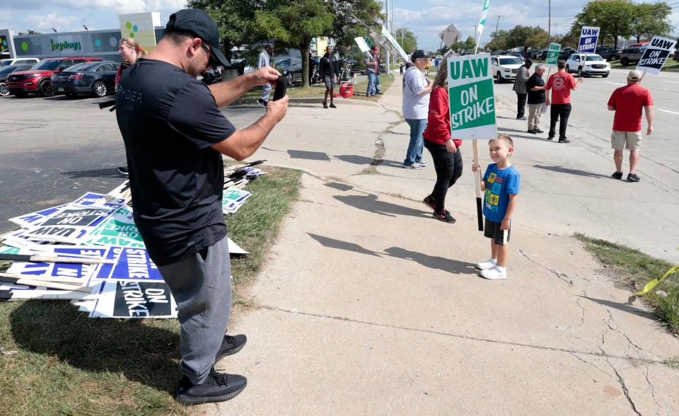 Darko Avramovski, 45 from Macomb and a sub assembly worker at Ford Motor Company Michigan Assembly plant wanted his son, Luca Avramovski, 4, to be a part of the strike experience and photographed him in front of Local 900 in Wayne on Friday, Sept. 15, 2023.