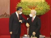 Vietnamese Communist Party General Secretary Nguyen Phu Trong and Chinese Foreign Minister Wang Yi elbow as they meet in Hanoi, Vietnam on Saturday, Sep.11, 2021. China has pledged to donate 3 million doses of its vaccine to Vietnam as Wang closed his visit to Hanoi. (Le Tri Dung/VNA via AP)