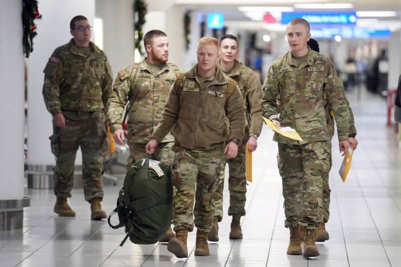 Soldiers on holiday leave walk through the terminal at St. Louis Lambert International Airport on Tuesday. Photo by Bill Greenblatt/UPI