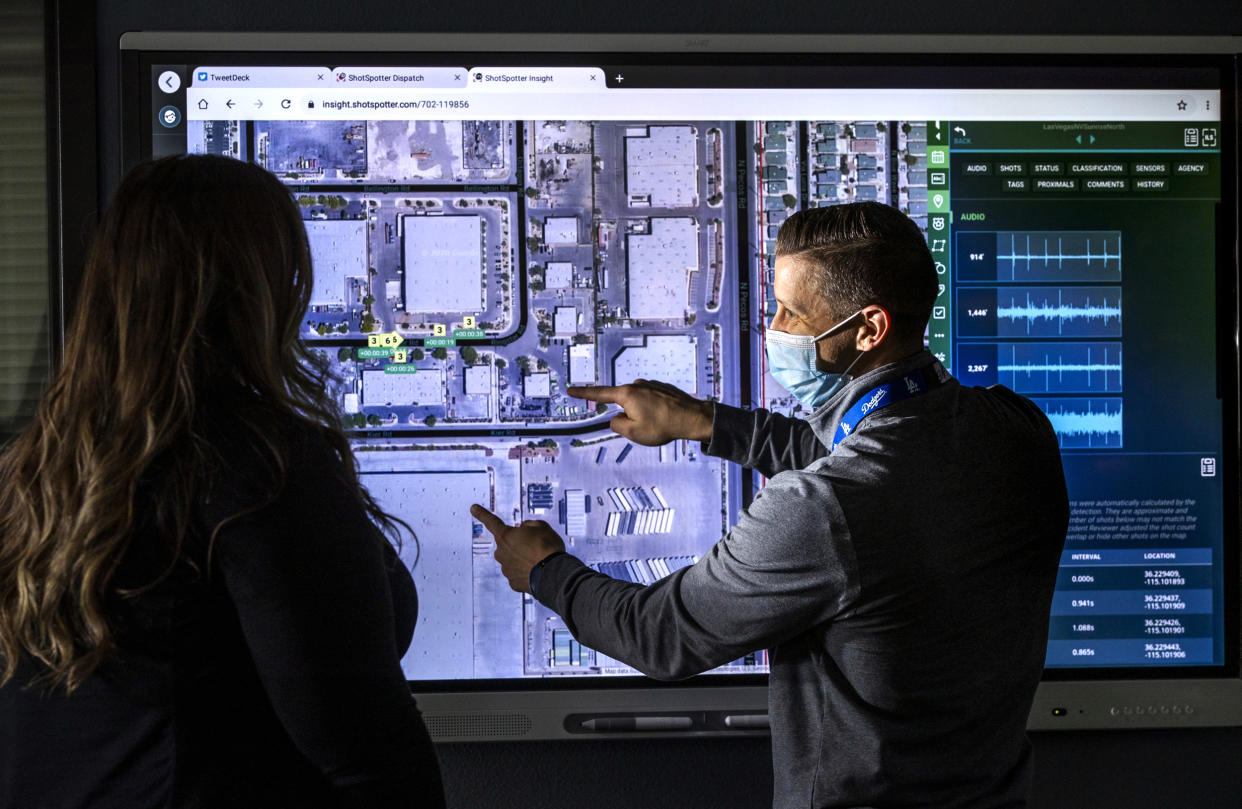 Image: Las Vegas Police Department Detective Kyle Downie, right, shows specialist Amber Stringer the ShotSpotter dispatch program at police headquarters on Jan. 13, 2021. (L.E. Baskow / Las Vegas Review-Journal via AP file)