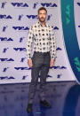 <p>Calvin Harris wore a collared shirt covered in feathers. (Photo: Getty Images) </p>