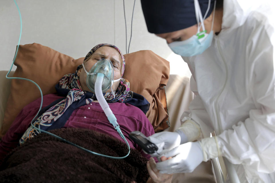 A nurse tends to a patient affected by COVID-19, at the Shohadaye Tajrish Hospital in Tehran, Iran, Sunday, April 18, 2021. After facing criticism for downplaying the virus last year, authorities have put partial lockdowns and other measures in place to try and slow the coronavirus’ spread, as Iran faces what looks like its worst wave of the coronavirus pandemic yet. (AP Photo/Ebrahim Noroozi)