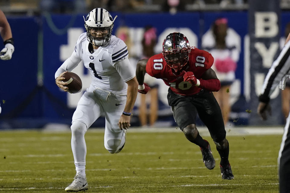 BYU quarterback Zach Wilson (1) out runs Western Kentucky defensive end DeAngelo Malone (10) during the first half of an NCAA college football game Saturday, Oct. 31, 2020, in Provo, Utah. (AP Photo/Rick Bowmer, Pool)