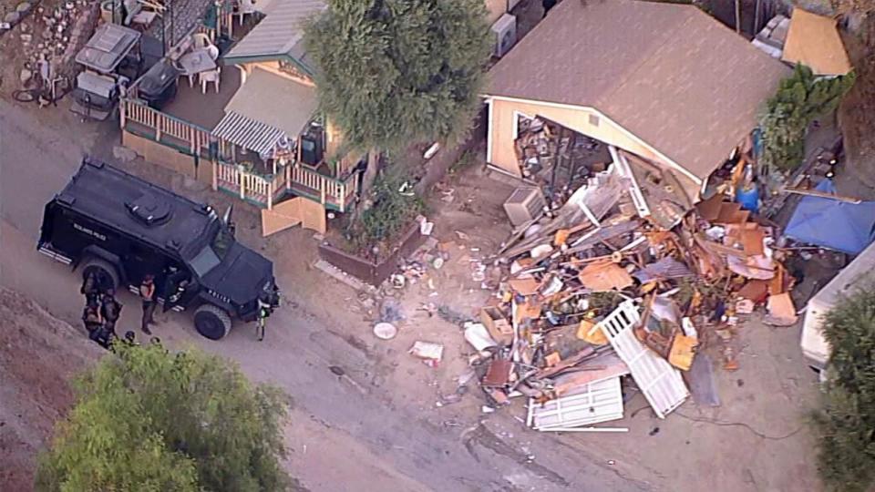 PHOTO: Police used an armored vehicle with a hydraulic battering ram to tear down a home on Keissel Road as they searched for missing couple, Stephanie Menard, 73, and her husband, Daniel, 79 in Redlands, Calif. (KABC)