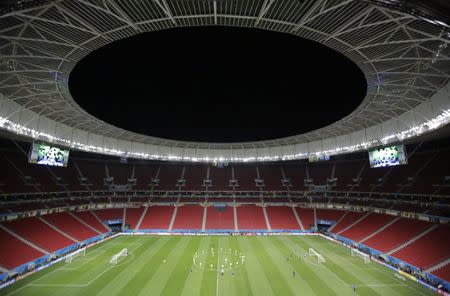 Members of the Brazil team stretch during a team soccer training session at the national stadium in Brasilia ahead of their 2014 World Cup Group A soccer match against Cameroon June 22, 2014. REUTERS/Ueslei Marcelino