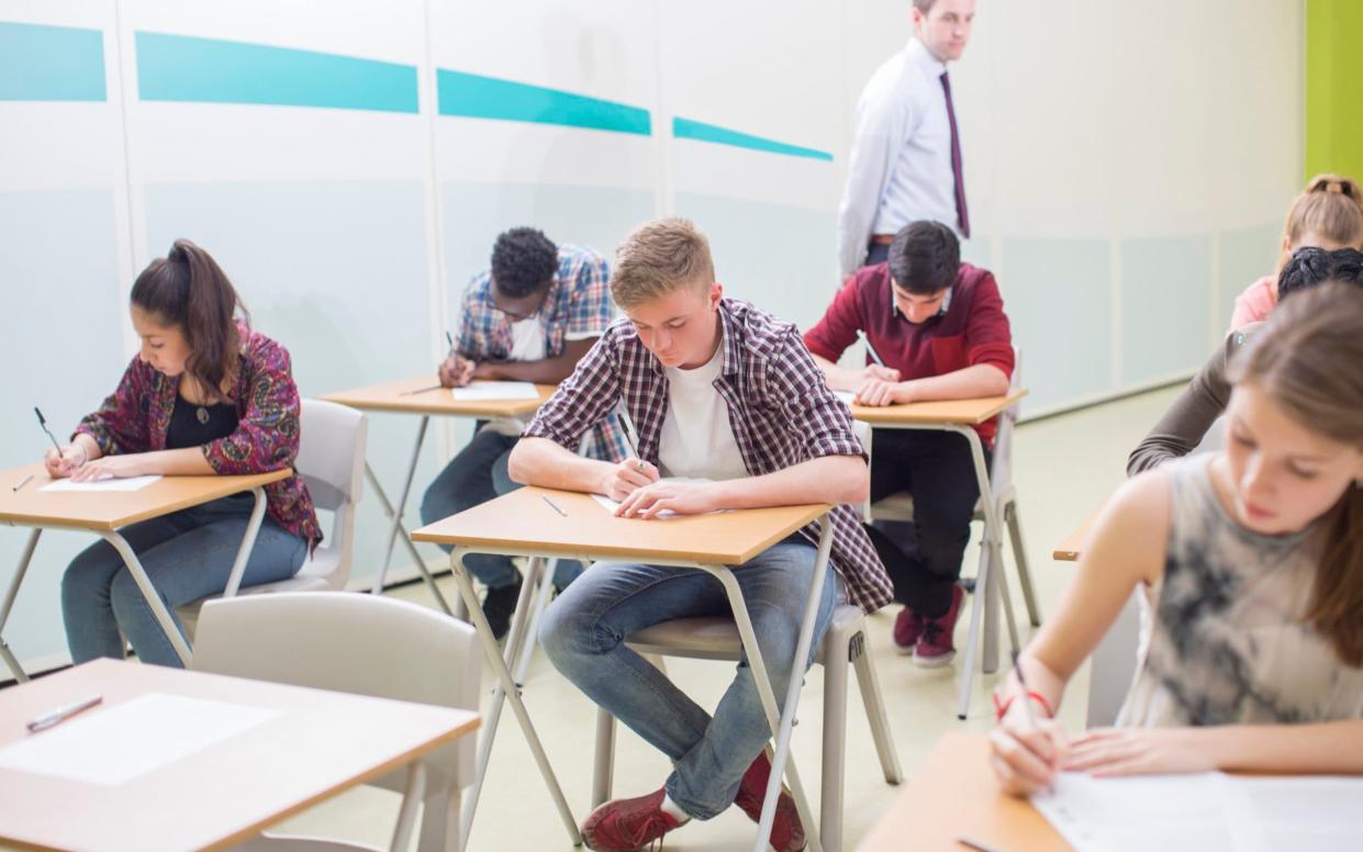 A stock photograph showing pupils sitting an exam