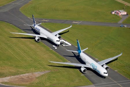 An Airbus A350-1000 and an Airbus A330 NEO are seen during the 53rd International Paris Air Show at Le Bourget Airport near Paris