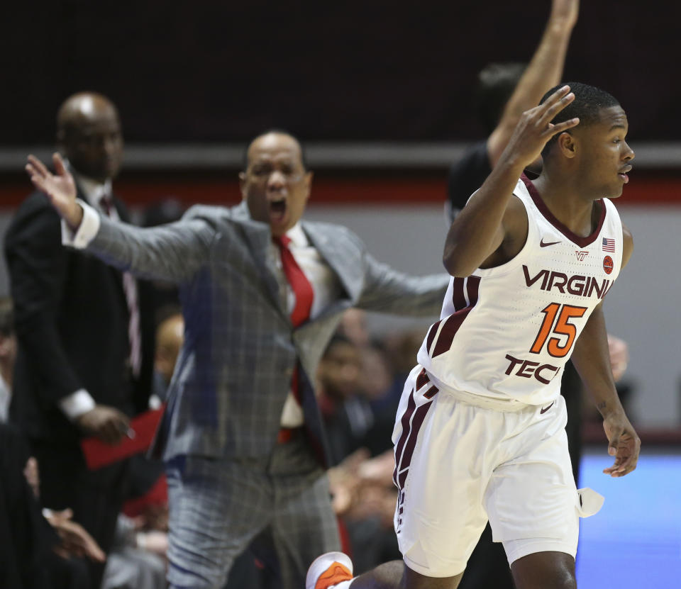 Virginia Tech's Jalen Cone (15) celebrates a 3-point basket in front of the NC State bench in the first half of an NCAA college basketball game Saturday, Jan. 11, 2020, in Blacksburg, Va. (Matt Gentry/The Roanoke Times via AP)