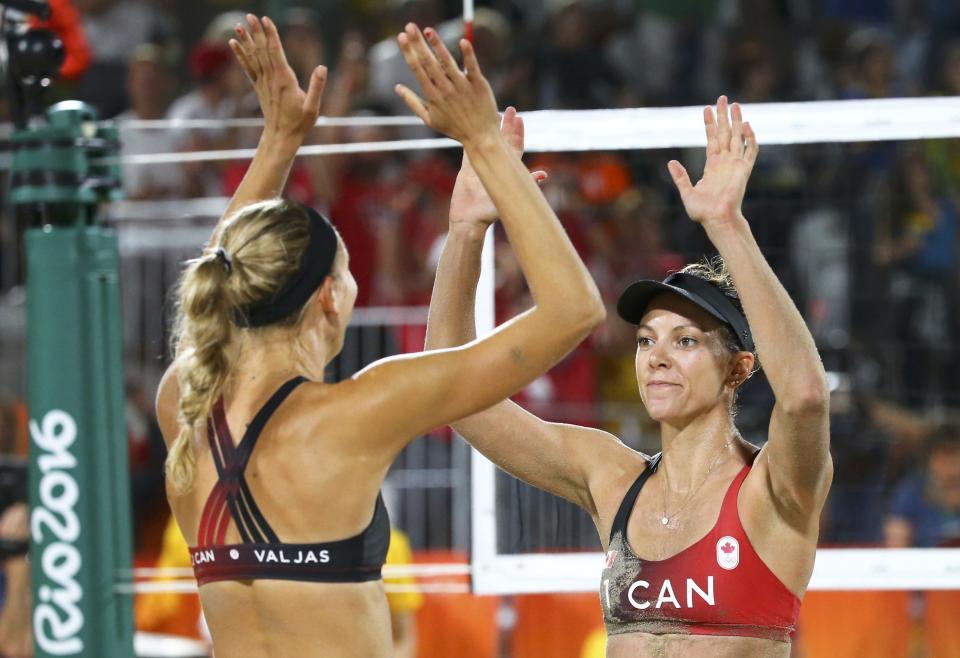 2016 Rio Olympics - Beach Volleyball - Women&#39;s Preliminary - Beach Volleyball Arena - Rio de Janeiro, Brazil - 07/08/2016. Jamie Lynn Broder (CAN) of Canada and Kristina Valjas (CAN) of Canada celebrate.   REUTERS/Ruben Sprich  FOR EDITORIAL USE ONLY. NOT FOR SALE FOR MARKETING OR ADVERTISING CAMPAIGNS.