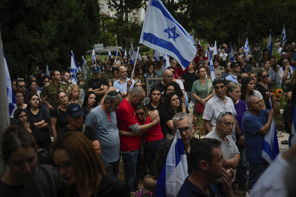 FILE - Mourners attend the funeral of Sgt. Roni Eshel in Kfar Saba, Israel on Nov. 12, 2023. Eshel was killed during Hamas' bloody cross-border rampage on Oct. 7, 2023. As the military sets its sights on southern Gaza in its campaign to stamp out Hamas, key challenges loom. International patience for a protracted invasion has begun to wear thin. And with some 2 million displaced Gaza residents staying in crowded shelters in the south in dire conditions, a broad military offensive there could unleash a new humanitarian disaster during the cold, wet winter. (AP Photo/Ariel Schalit, File)