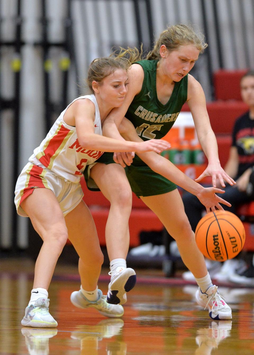 Mooney's Josie Maloni (#5) and Tampa Catholic's Emily Martelli (#12) battle for a loose ball. Cardinal Mooney hosted Tampa Catholic in the girls basketball regional semi-final on Tuesday night. 