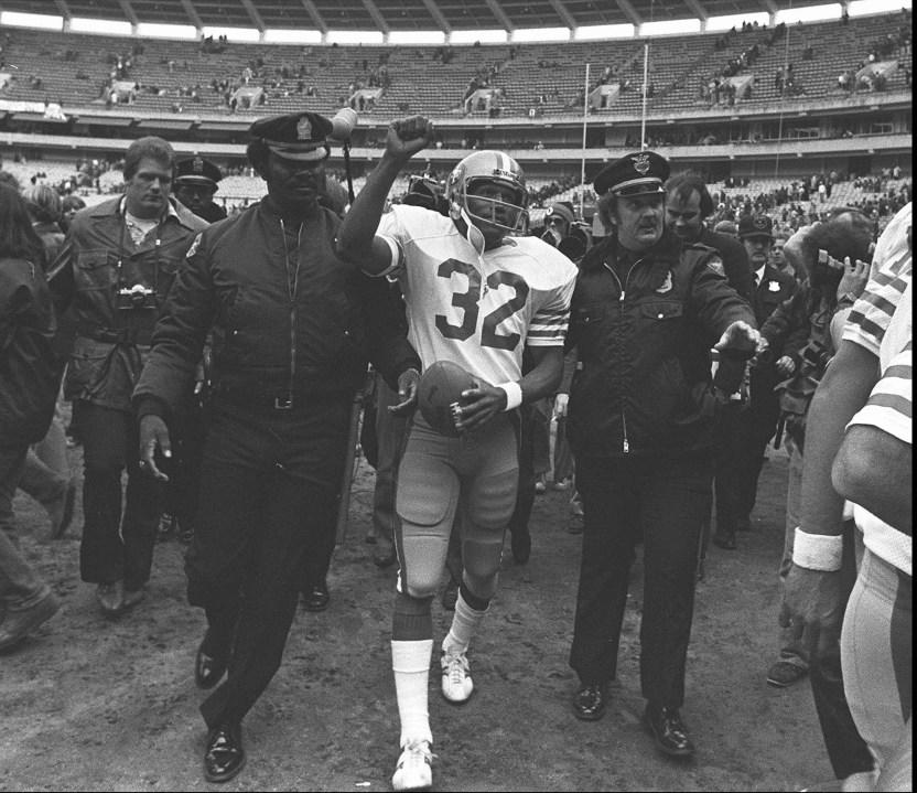 FILE – In this Dec. 16, 1979 file photo, San Francisco 49ers running back O.J. Simpson is escorted from the field by police after the final NFL football game of his career against in the Atlanta Falcons at Atlanta Fulton County Stadium in Atlanta, Ga. Simpson retired from football after the 1979 season, later being inducted into the Pro Football Hall of Fame and beginning careers in acting and football broadcasting. A Nevada prison official said early Sunday, Oct. 1, 2017, O.J. Simpson, the former football legend and Hollywood star, has been released from a Nevada prison in Lovelock after serving nine years for armed robbery. (AP Photo, File)