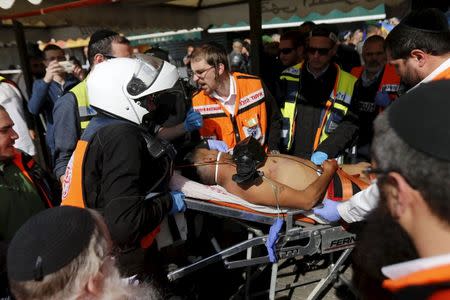 Israeli medics evacuate a wounded Palestinian who police said ran towards them with a knife near Jerusalem's Old City November 10, 2015. REUTERS/Ammar Awad