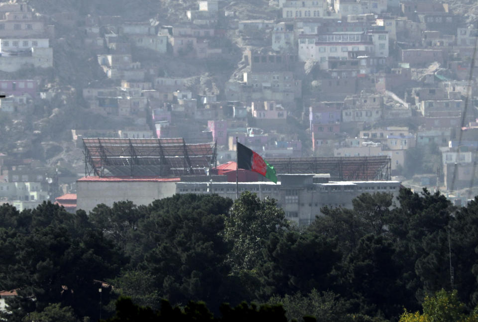 FILE - The Afghan flag flies atop the presidential palace in Kabul, Afghanistan, Tuesday, Aug. 17, 2021. On Friday, Aug. 20, 2021, The Associated Press reported on a photo circulating online that was digitally altered to make it appear that the Taliban flag was flying on the tower of the palace in Kabul on Sunday, Aug. 15, 2021. (AP Photo/Rahmat Gul, File)