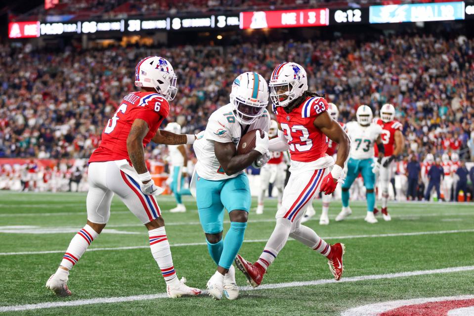 Sep 17, 2023; Foxborough, Massachusetts, USA; Miami Dolphins receiver Tyreek Hill (10) scores a touchdown during the first half against the New England Patriots at Gillette Stadium. Mandatory Credit: Paul Rutherford-USA TODAY Sports