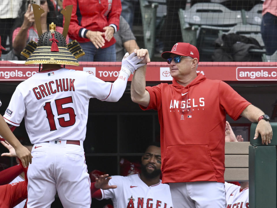 Los Angeles Angels right fielder Randal Grichuk is congratulated for his home run by Manager Phil Nevin during the third inning of a baseball game Sunday, Oct. 1, 2023, in Anaheim, Calif. (AP Photo/John McCoy)