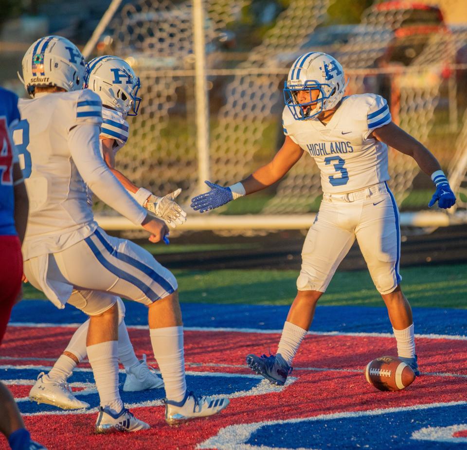 Cam Giesler of Highlands celebrates with Brody Benke and another teammate after scoring a touchdown in the game between Highlands and Conner high schools Friday, Sept. 30, 2022.