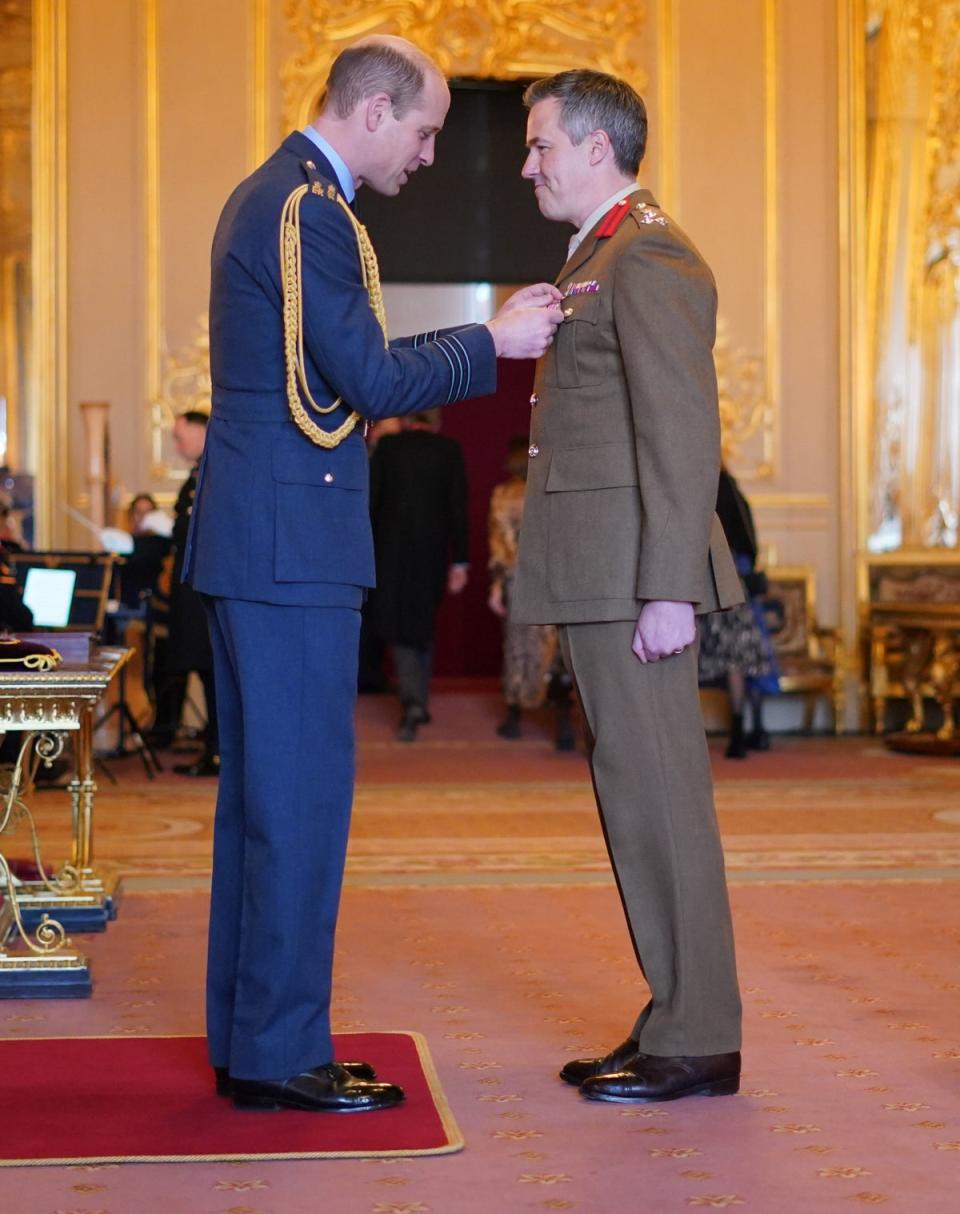 Brigadier Tobias Lambert is made an Officer of the Order of the British Empire by the Prince of Wales at Windsor Castle (PA)