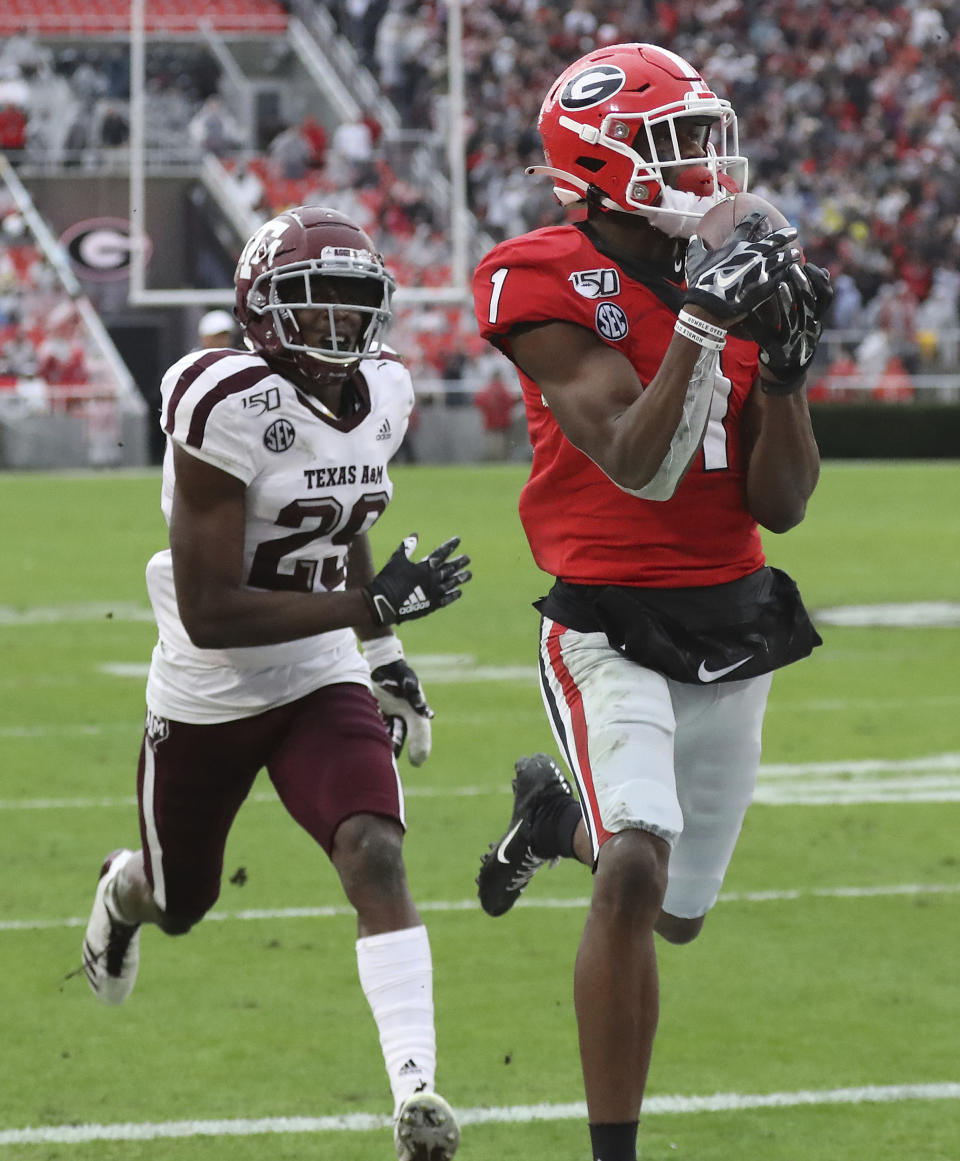 Georgia wide receiver George Pickens (1) makes a catch for a touchdown as Texas A&M defensive back Debione Renfro (29) defends in the first half of an NCAA college football game Saturday, Nov. 23, 2019, in Athens, Ga. (Curtis Compton/Atlanta Journal-Constitution via AP)
