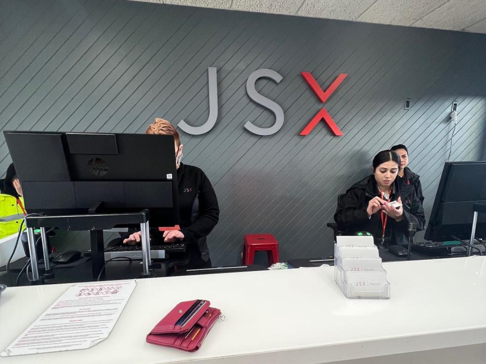 The JSX check-in counter with computers and a JSX sign on the wall.