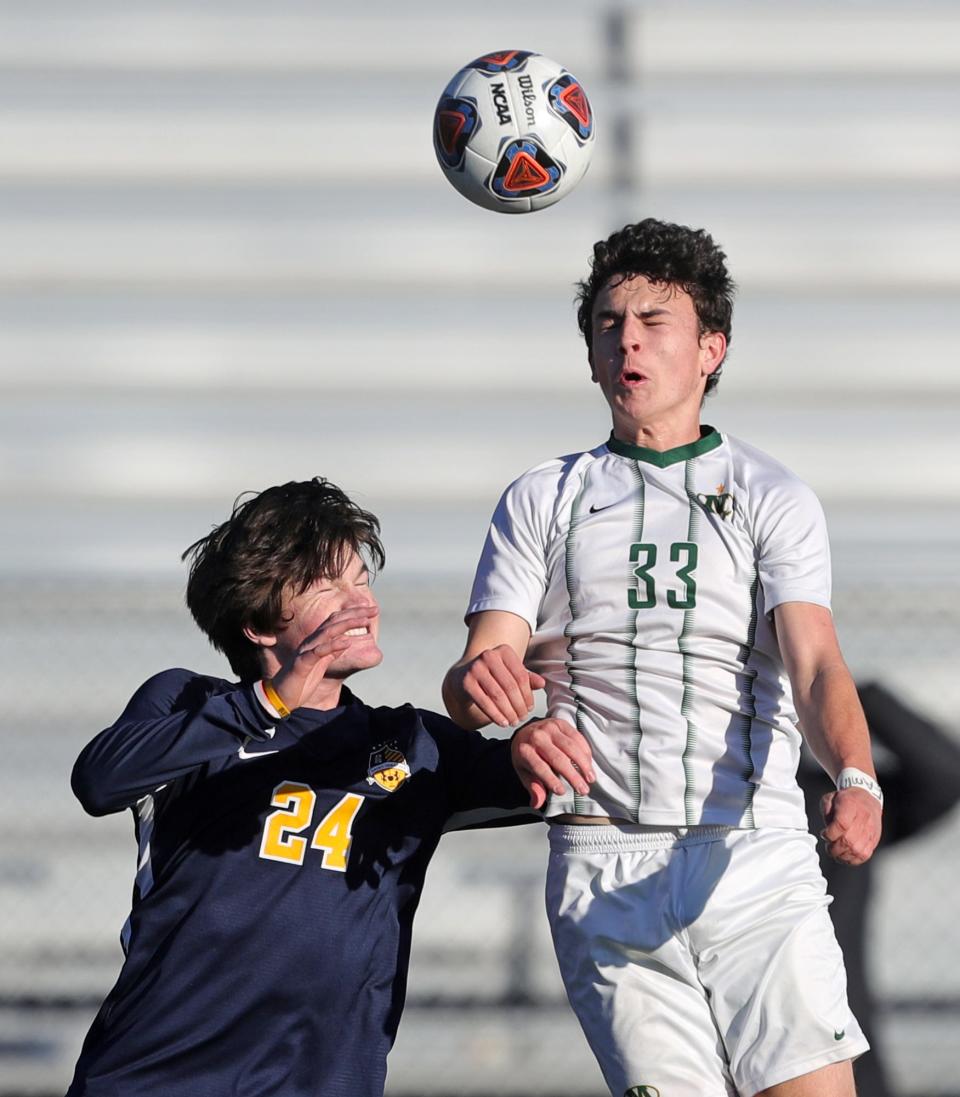 Medina's Nate Werthmuller, right, heads the ball over Owen Sullivan of St. Ignatius during the first half of a Division I regional championship game, Saturday, Nov. 6, 2021, in Brunswick, Ohio.