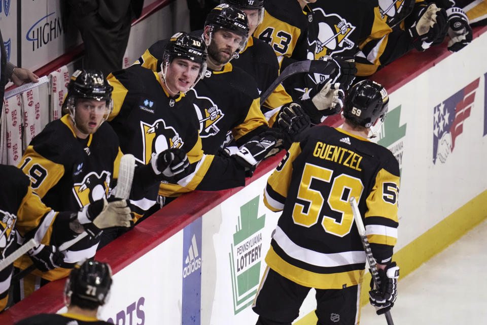 Pittsburgh Penguins' Jake Guentzel (59) returns to the bench after scoring against the Montreal Canadiens during the second period of an NHL hockey game in Pittsburgh, Tuesday, March 14, 2023. (AP Photo/Gene J. Puskar)