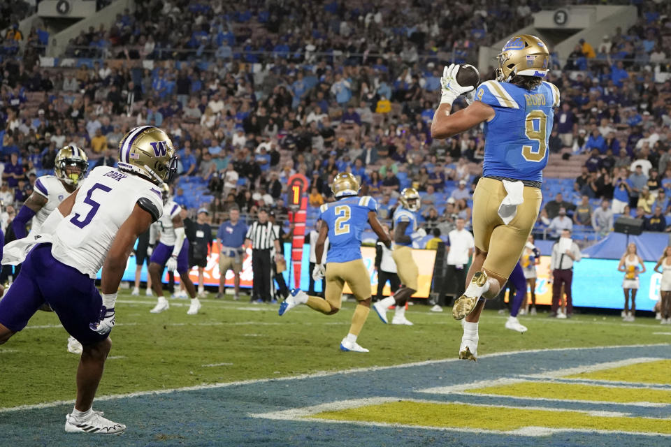 UCLA wide receiver Jake Bobo (9) makes a touchdown catch past Washington safety Alex Cook (5) during the first half of an NCAA college football game Friday, Sept. 30, 2022, in Pasadena, Calif. (AP Photo/Marcio Jose Sanchez)