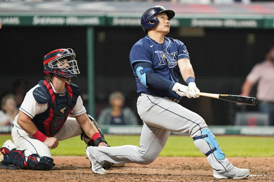 Tampa Bay Rays' Ji-Man Choi watches his three-run home run next to Cleveland Indians catcher Austin Hedges in the ninth inning of a baseball game Friday, July 23, 2021, in Cleveland. (AP Photo/Tony Dejak)