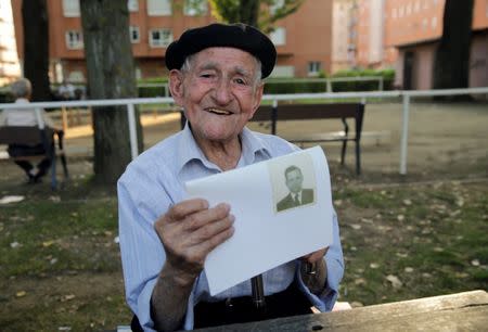 Maximino San Miguel, 102, holds a picture of himself when he was young as he poses for a portrait in a park near his home in Leon, northern Spain, September 3, 2016. San Miguel discovered his passion for amateur dramatics at the age of 80 and has participated in many local productions. He didnÕt go to school as a child because he was sent to work as a shepherd. He enjoys reading books about traditions. REUTERS/Andrea Comas