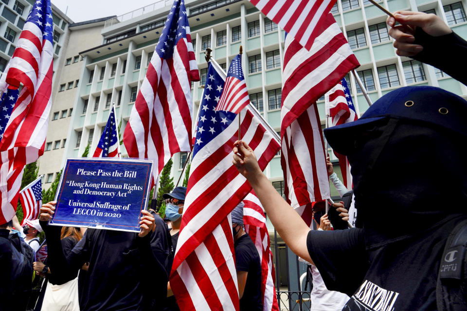 Protesters wave United States flags during a protest in Hong Kong, Sunday, Sept. 8, 2019. Demonstrators in Hong Kong plan to march to the U.S. Consulate on Sunday to drum up international support for their protest movement, a day after attempts to disrupt transportation to the airport were thwarted by police. (AP Photo/Vincent Yu)