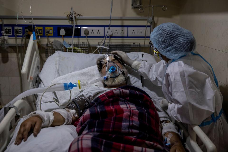 A medical worker tends to a patient suffering from the coronavirus disease (COVID-19), inside the ICU ward at Holy Family Hospital in New Delhi, India,