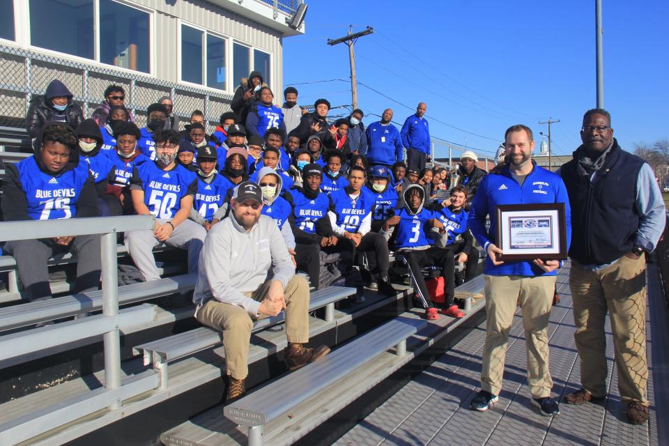 Former New England Patriots linebacker and NFL Hall of Famer Andrew Tippett presented Randolph High football coach Jonathan Marshall with the Patriots High School Football Coach of the Year Award.