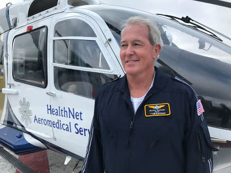 Helicopter pilot Mike Woodward, who works for Air Methods Coproration, flying for Helthnet Aeromedical Services poses on the rooftop of West Virginia University Hospital in Morgantown, West Virginia, U.S., September 7, 2017. Photo taken September 7, 2017. REUTERS/Mike Wood