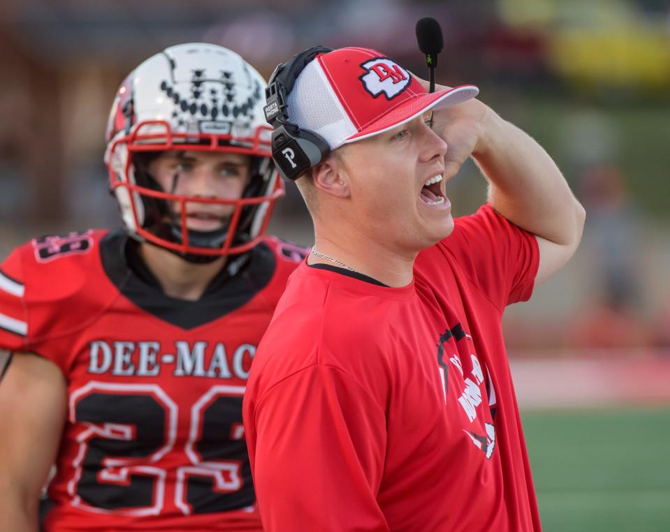 Dee-Mack head coach Cody Myers yells instructions to his players in the first half of their Week 2 football game against Gibson City-Melvin-Sibley on Friday, Sept. 1, 2023 in Mackinaw.