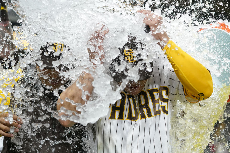 San Diego Padres' Ha-Seong Kim, center, is doused after hitting a walk-off home run to defeat the Arizona Diamondbacks 5-4 in a baseball game Monday, April 3, 2023, in San Diego. (AP Photo/Gregory Bull)