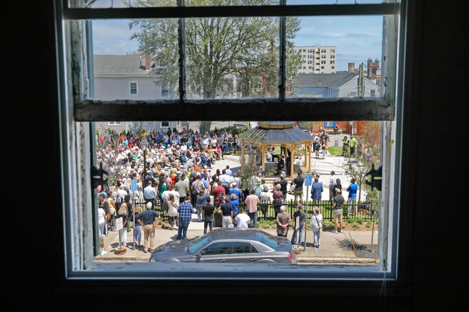 The Abolition Row Park dedication is seen through the window of the Nathan & Polly Johnson House where Frederick Douglass lived in during his stay in New Bedford.