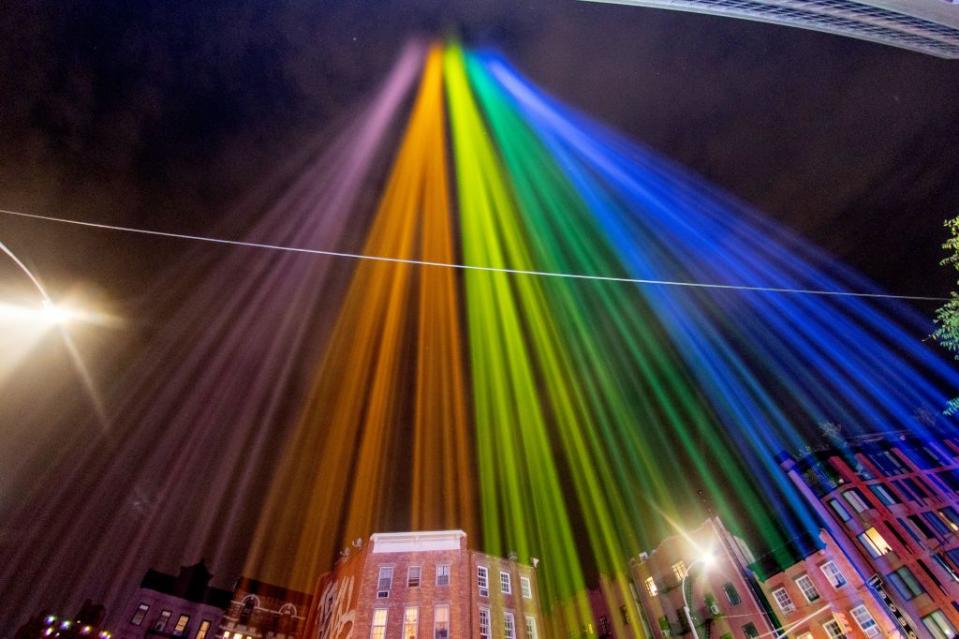 <p>A view of Pride coloured lights are projected into the sky on June 27, 2020 in New York City.</p>