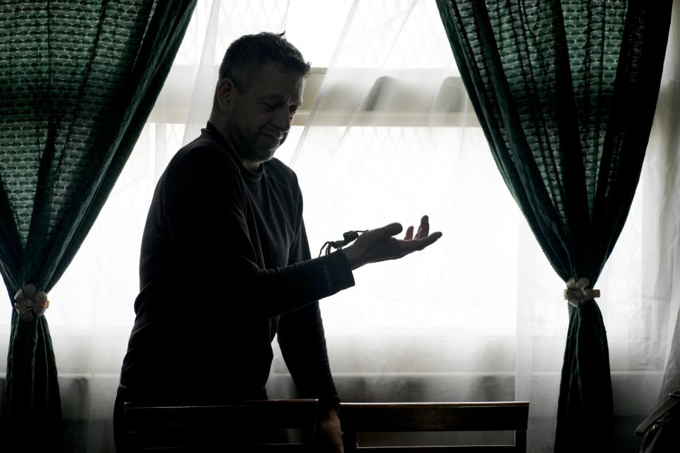 Nurse Osvaldo Negri holds a tarantula, one of his 60 pet spiders in Lanus, Argentina, Thursday, Sept. 9, 2021. The 50-year-old nurse said he began raising spiders to overcome arachnophobia and that caring for them has helped him cope with working at the hospital in the midst of COVID-19, “unplugging” as he watches and sometimes touches the spiders, feeding them cockroaches. (AP Photo/Natacha Pisarenko)