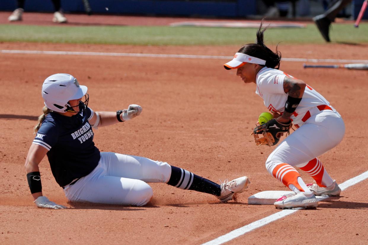 BYU catcher Hailey Morrow (20) slides to third as Oklahoma State infielder Tallen Edwards (44) bobbles the ball in the first inning of a Big 12 softball game between the Oklahoma State Cowgirls (OSU) and BYU at Devon Park in Oklahoma City, Thursday, May 9, 2024. BYU won 7-2.