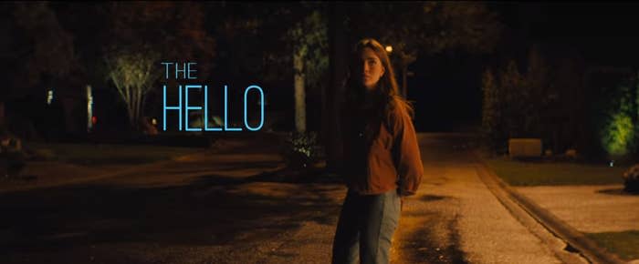 Clare standing outside at night with the words "the hello"