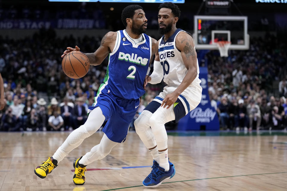 Dallas Mavericks guard Kyrie Irving (2) works against Minnesota Timberwolves' Mike Conley, right, in the second half of an NBA basketball game, Monday, Feb. 13, 2023, in Dallas. (AP Photo/Tony Gutierrez)