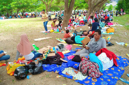 Residents sit on the ground after an earthquake hit at outside of Mutiara Sis Al Jufri airport in Palu, Indonesia Sulawesi Island, September 29, 2018. Antara Foto/Rolex Malaha via REUTERS