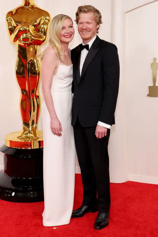 <p>Mike Coppola/Getty</p> Kirsten Dunst and Jesse Plemons have glam date night at 2024 Oscars