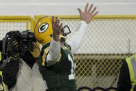 Green Bay Packers quarterback Aaron Rodgers celebrates his one-yard touchdown run during the first half of an NFL divisional playoff football game against the Los Angeles Rams, Saturday, Jan. 16, 2021, in Green Bay, Wis. (AP Photo/Morry Gash)