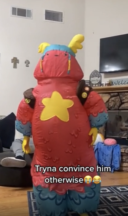A kid in a costume with a ridged top, with the caption "Tryna convince him otherwise" and laughing emojis