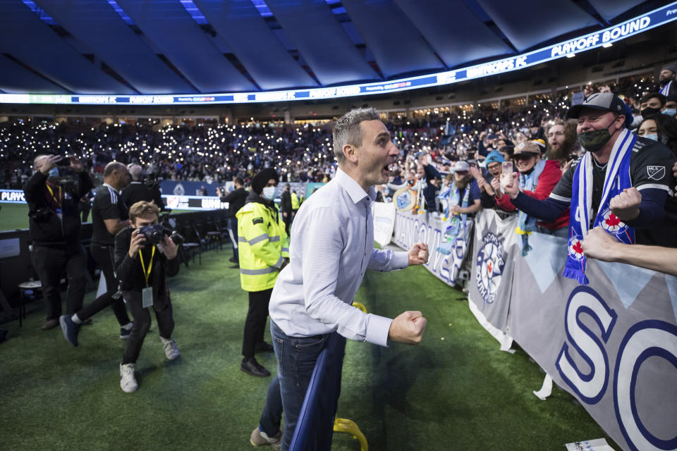 Vancouver Whitecaps acting head coach Vanni Sartini celebrates after Vancouver qualified for the playoffs after a draw with the Seattle Sounders in an MLS soccer game in Vancouver, British Columbia, Sunday, Nov. 7, 2021. (Darryl Dyck/The Canadian Press via AP)