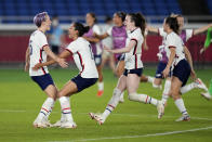 United States' Megan Rapinoe, left, celebrates with teammates after scoring the winning goal and defeating the Netherlands in a penalty shootout during a women's quarterfinal soccer match at the 2020 Summer Olympics, Friday, July 30, 2021, in Yokohama, Japan. (AP Photo/Silvia Izquierdo)