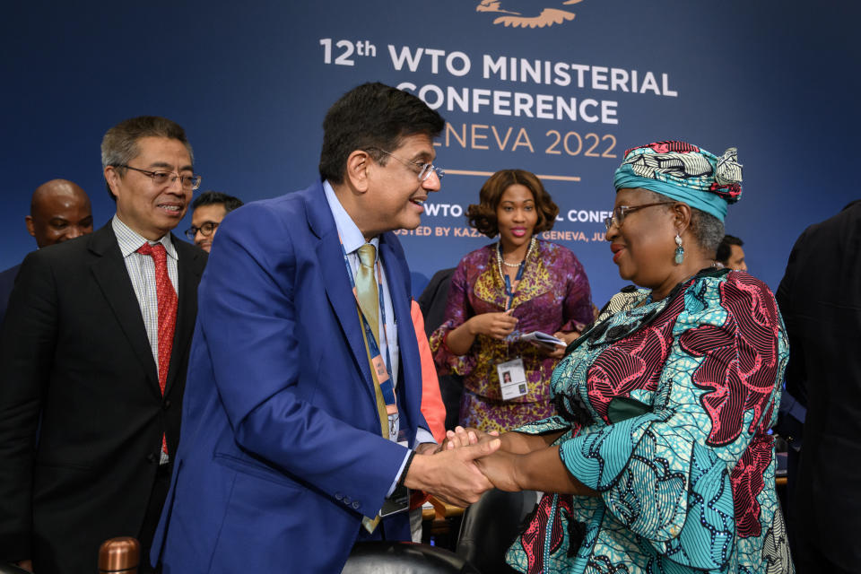 World Trade Organization Director-General Ngozi Okonjo-Iweala, right, is congratulated by Indian Minister of Commerce Piyush Goyal after a closing session of a World Trade Organization Ministerial Conference at the WTO headquarters in Geneva early Friday, June 17, 2022. (Fabrice Coffrini/Pool Photo/Keystone via AP)