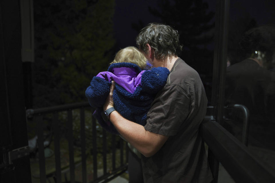 Andrew Hackney hands his 1-year-old daughter back to the Office of Children, Youth and Families services at the end of one of their twice weekly supervised visits in Oakdale, Pa., on Thursday, Nov. 17, 2022. At 7 months old, Andrew and his wife, Lauren, had difficulty feeding their daughter and brought her to the children's hospital in Pittsburgh. They believe hospital staff alerted the Allegheny County Department of Human Services because the baby was severely dehydrated and malnourished, which resulted in removing the young child from their custody. The Hackneys and their lawyer believe the Allegheny County Family Screening artificial intelligence tool may have flagged the couple as dangerous because of their disabilities. (AP Photo/Jessie Wardarski)